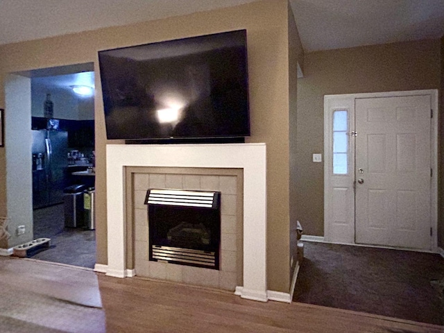 133 Heather Glen Dr Unit 133, Aurora, IL 60504 - unfurnished living room with a tiled fireplace and wood finished floors
