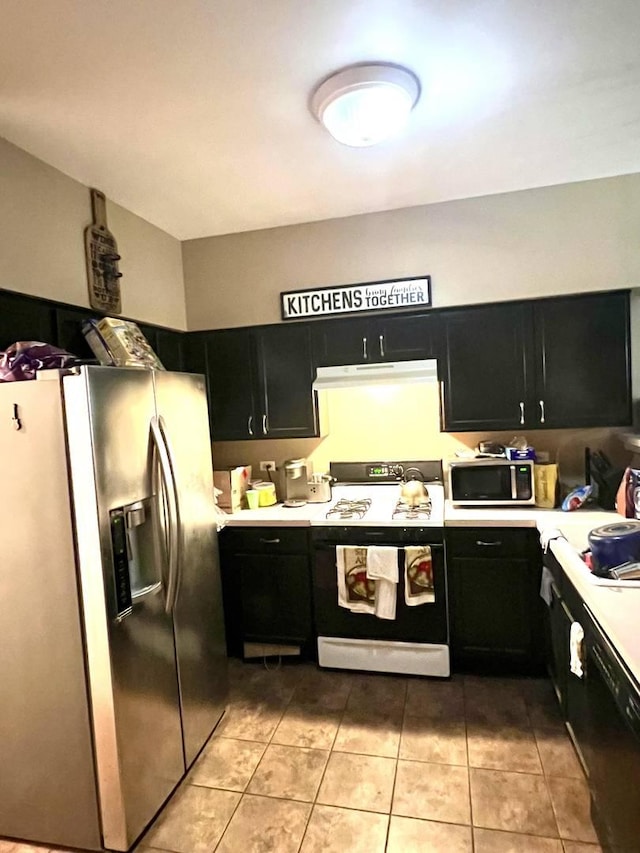 133 Heather Glen Dr Unit 133, Aurora, IL 60504 - kitchen featuring appliances with stainless steel finishes, dark cabinets, light countertops, under cabinet range hood, and light tile patterned flooring