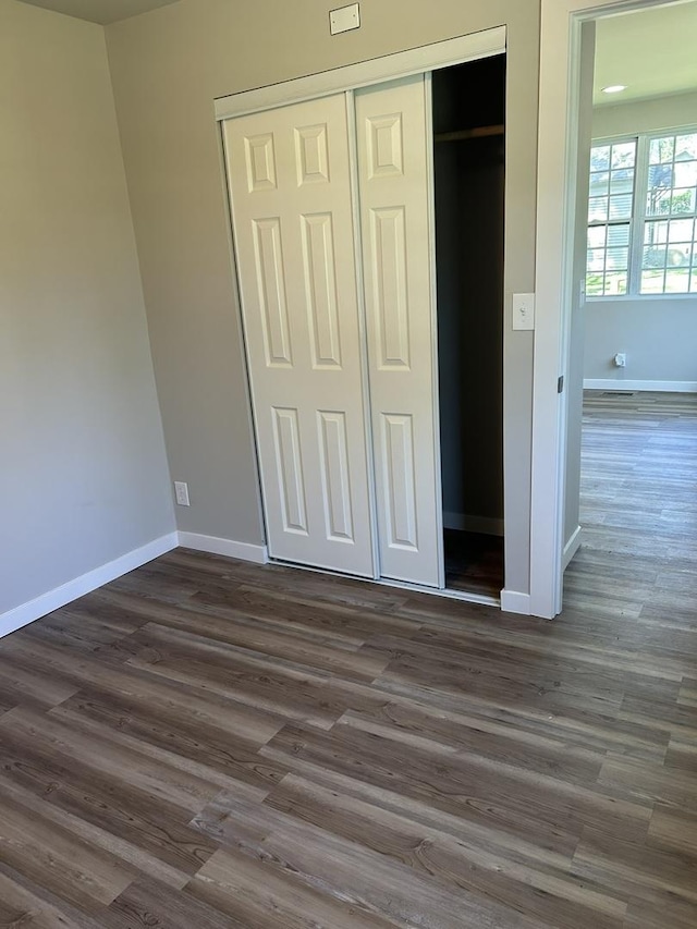 5309 Cleveland Dr, Mchenry, IL 60050 - unfurnished bedroom with a closet and dark wood-style flooring