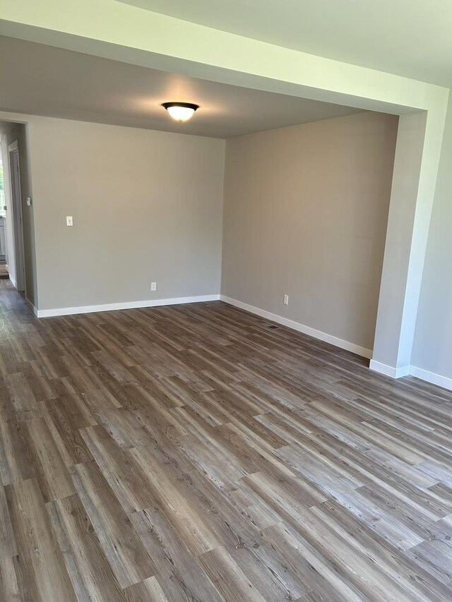 5309 Cleveland Dr, Mchenry, IL 60050 - spare room featuring dark wood-style flooring and baseboards