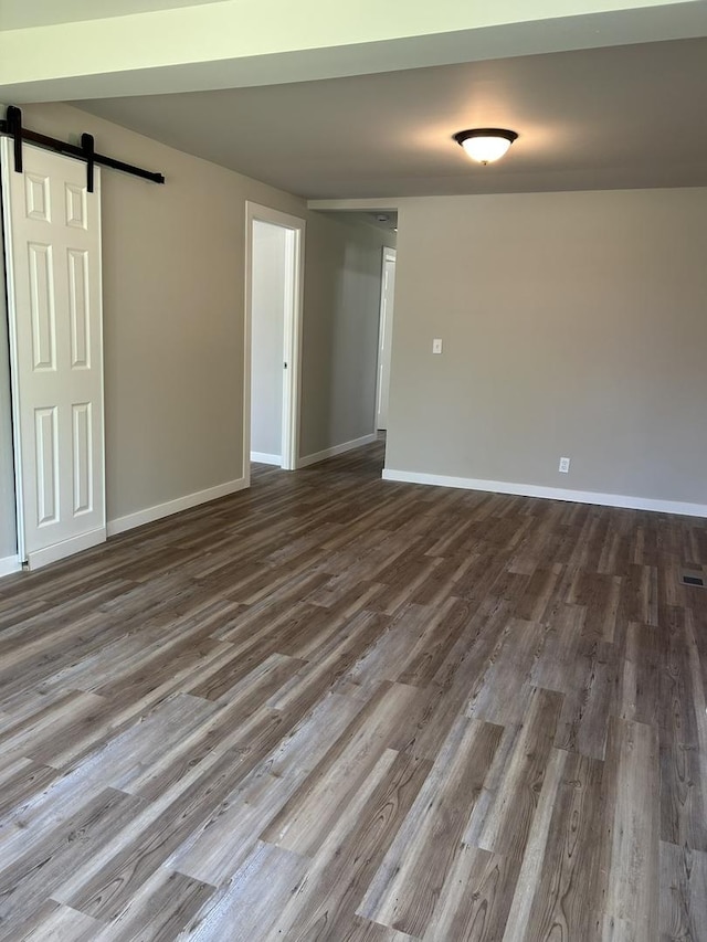 5309 Cleveland Dr, Mchenry, IL 60050 - unfurnished room with a barn door and dark wood-style floors