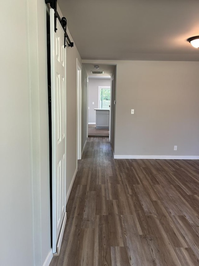 5309 Cleveland Dr, Mchenry, IL 60050 - corridor featuring a barn door and dark wood-style floors