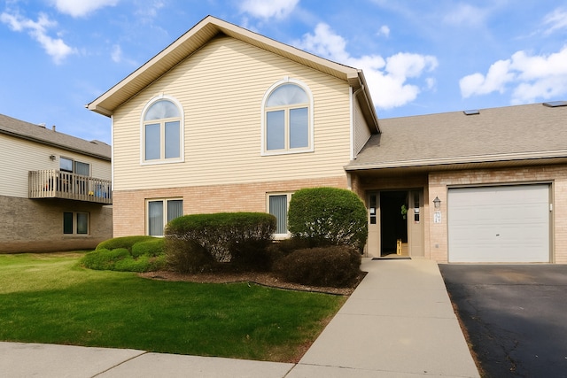 174 Barbara Jean Ln Unit 1, Joliet, IL 60436 - view of front facade featuring brick siding, driveway, a front yard, and an attached garage