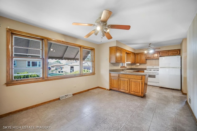 11258 S Trumbull Ave S, Chicago, IL 60655 - kitchen with white appliances, a ceiling fan, a peninsula, and brown cabinetry
