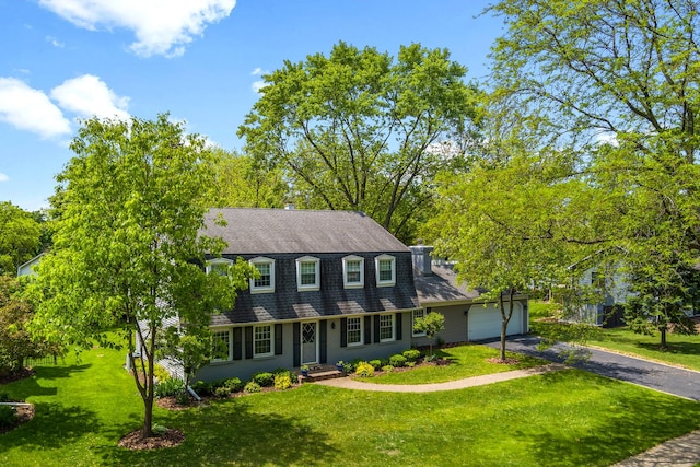 25W303 Gunston Ave, Naperville, IL 60540 - colonial inspired home with asphalt driveway, roof with shingles, a garage, and a front lawn