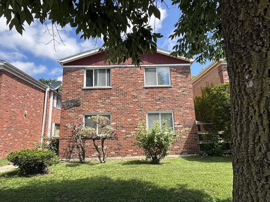 704 W 111th St, Chicago, IL 60628 - back of house featuring a yard and brick siding