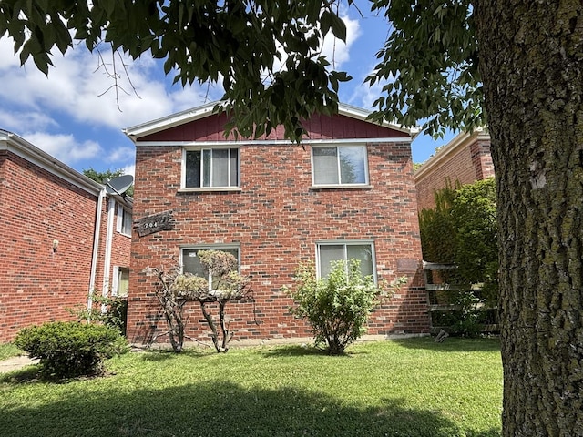 704 W 111th St, Chicago, IL 60628 - back of house featuring a yard and brick siding
