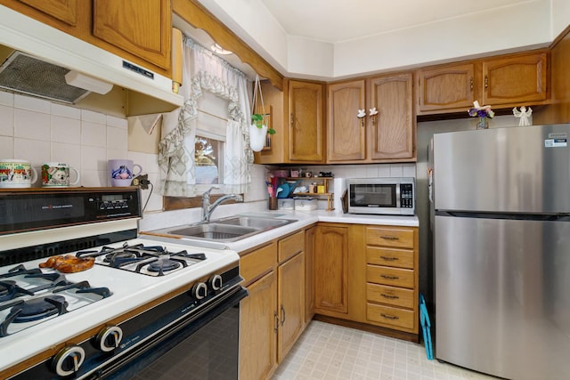 2551 Elm St, River Grove, IL 60171 - kitchen with appliances with stainless steel finishes, under cabinet range hood, light countertops, and brown cabinets