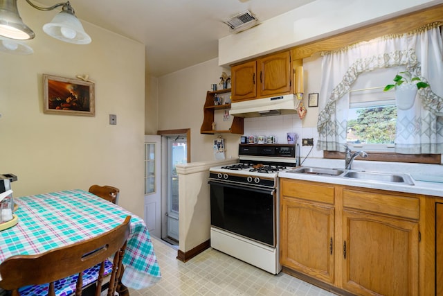 2551 Elm St, River Grove, IL 60171 - kitchen with white range with gas cooktop, under cabinet range hood, light countertops, open shelves, and brown cabinetry