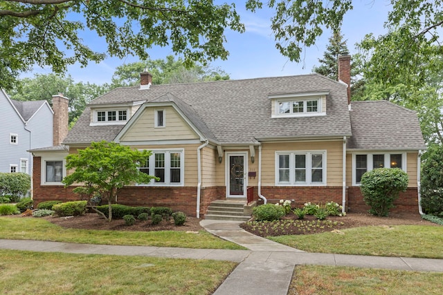 260 N Charlotte St, Lombard, IL 60148 - view of front of home with a chimney, brick siding, and a front yard