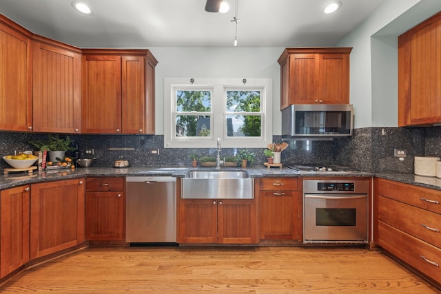 260 N Charlotte St, Lombard, IL 60148 - kitchen featuring appliances with stainless steel finishes, light wood finished floors, backsplash, dark stone counters, and recessed lighting