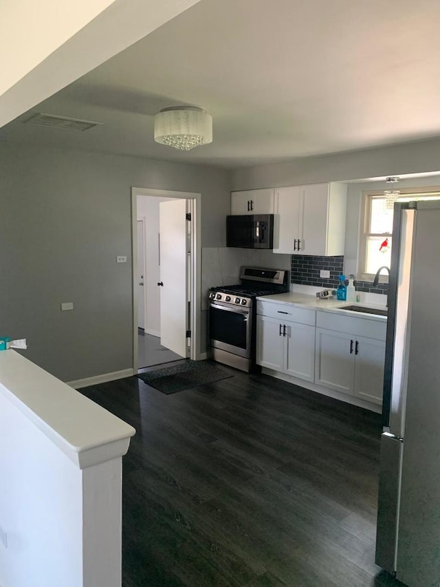 6425 W 83rd Pl, Burbank, IL 60459 - kitchen featuring stainless steel appliances, dark wood finished floors, white cabinets, tasteful backsplash, and light countertops
