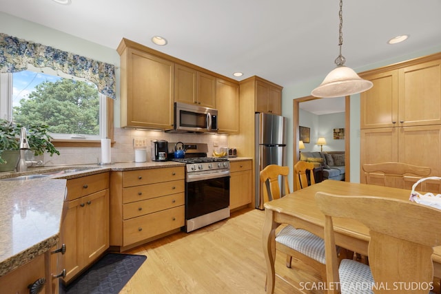 412 S Addison Ave, Lombard, IL 60148 - kitchen with stainless steel appliances, decorative backsplash, light wood-style flooring, decorative light fixtures, and light stone counters