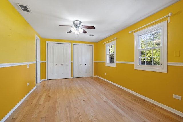 10409 S 83rd Ave, Palos Hills, IL 60465 - unfurnished bedroom featuring multiple closets, light wood-style floors, and ceiling fan