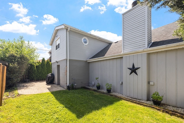 10409 S 83rd Ave, Palos Hills, IL 60465 - view of side of property featuring a chimney, roof with shingles, a patio, and board and batten siding