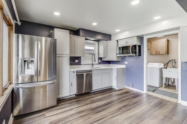 6105 W 83rd St, Burbank, IL 60459 - kitchen with stainless steel appliances, washer / dryer, light countertops, wood finished floors, and recessed lighting