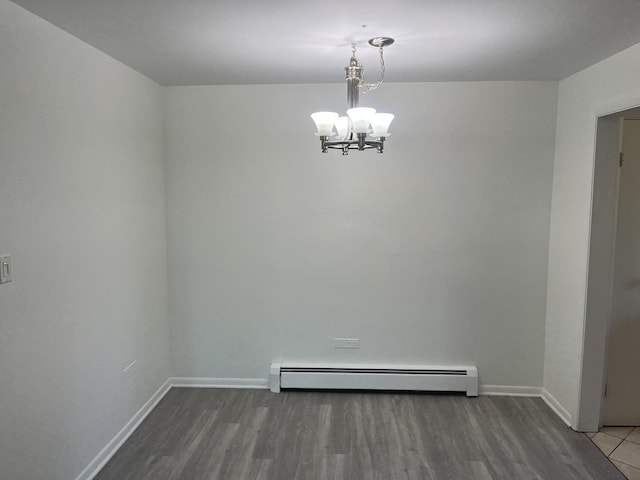 415 Wesley Ave Unit 21, Oak Park, IL 60302 - spare room with a chandelier, a baseboard heating unit, and wood finished floors