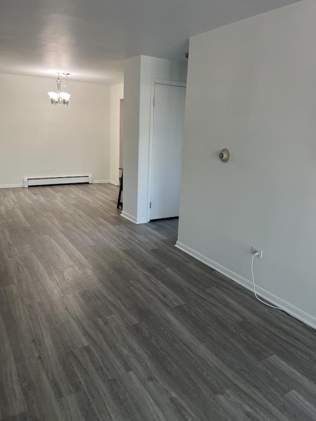 415 Wesley Ave Unit 21, Oak Park, IL 60302 - spare room with a baseboard heating unit, a chandelier, and dark wood-type flooring