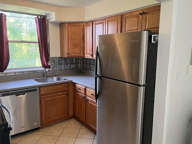 415 Wesley Ave Unit 21, Oak Park, IL 60302 - kitchen featuring stainless steel appliances, light tile patterned flooring, brown cabinets, and backsplash
