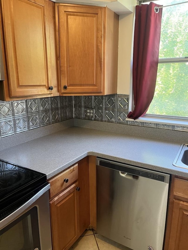 415 Wesley Ave Unit 21, Oak Park, IL 60302 - kitchen featuring stainless steel appliances, decorative backsplash, and brown cabinetry