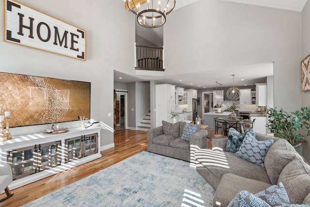 39W869 Kellar Sq, Geneva, IL 60134 - living area featuring wood finished floors, high vaulted ceiling, a chandelier, and stairway