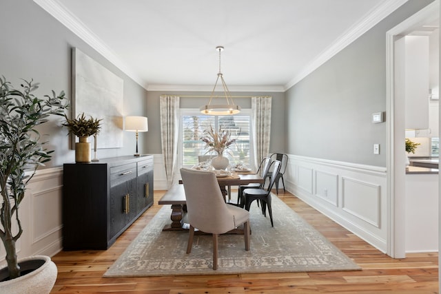 39W869 Kellar Sq, Geneva, IL 60134 - dining area featuring light wood-type flooring, ornamental molding, a decorative wall, and wainscoting