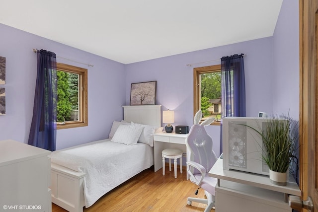 609 N Eastman Dr, Mount Prospect, IL 60056 - bedroom featuring multiple windows, wood finished floors, and a desk