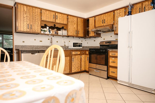 9275 W Noel Ave Unit 3C, Des Plaines, IL 60016 - kitchen featuring appliances with stainless steel finishes, exhaust hood, brown cabinets, and decorative backsplash