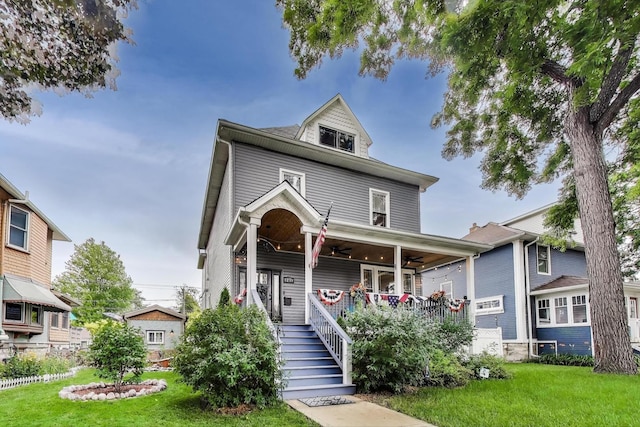 3239 Wesley Ave, Berwyn, IL 60402 - american foursquare style home featuring a ceiling fan, a porch, and a front lawn