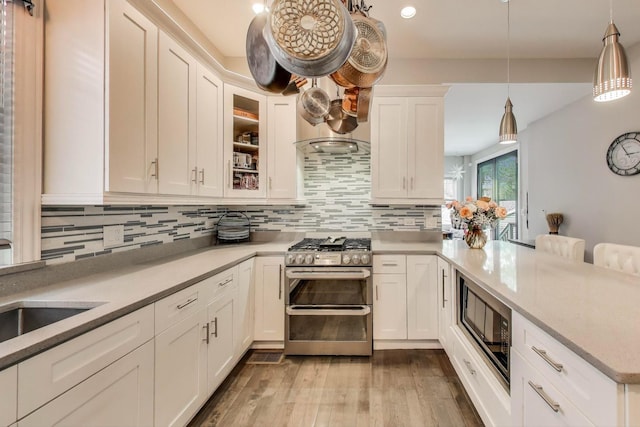 3239 Wesley Ave, Berwyn, IL 60402 - kitchen featuring range with two ovens, built in microwave, a peninsula, tasteful backsplash, and recessed lighting