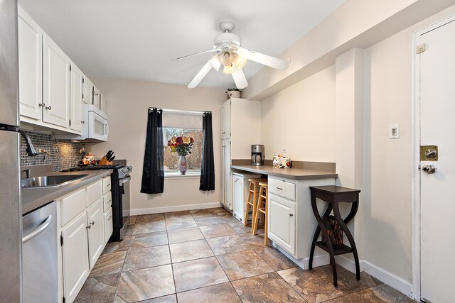 2650 Central Dr Unit Gs, Flossmoor, IL 60422 - kitchen with appliances with stainless steel finishes, white cabinets, tasteful backsplash, and a ceiling fan