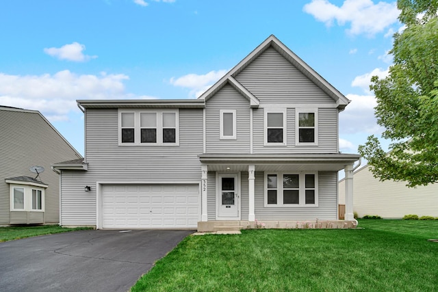 352 Westport Dr, Pingree Grove, IL 60140 - traditional home with an attached garage, asphalt driveway, covered porch, and a front yard