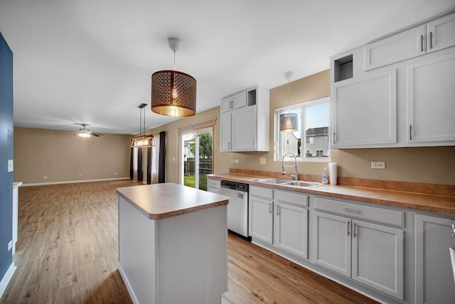 352 Westport Dr, Pingree Grove, IL 60140 - kitchen with stainless steel dishwasher, a center island, light wood-style floors, ceiling fan, and hanging light fixtures