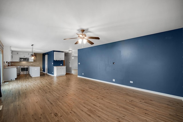 352 Westport Dr, Pingree Grove, IL 60140 - unfurnished living room with a ceiling fan and dark wood-style flooring