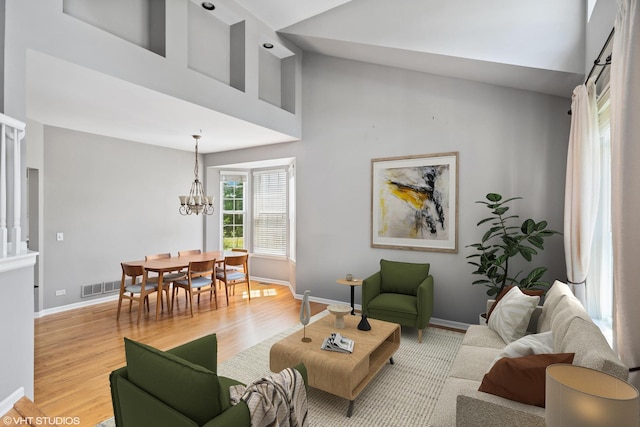 6162 Crossland Blvd, Gurnee, IL 60031 - living room with light wood-style flooring, high vaulted ceiling, and a chandelier