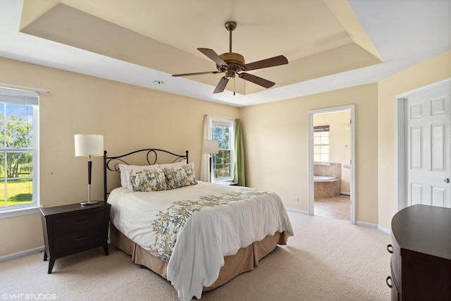 6162 Crossland Blvd, Gurnee, IL 60031 - bedroom with light carpet, a tray ceiling, multiple windows, and ensuite bath