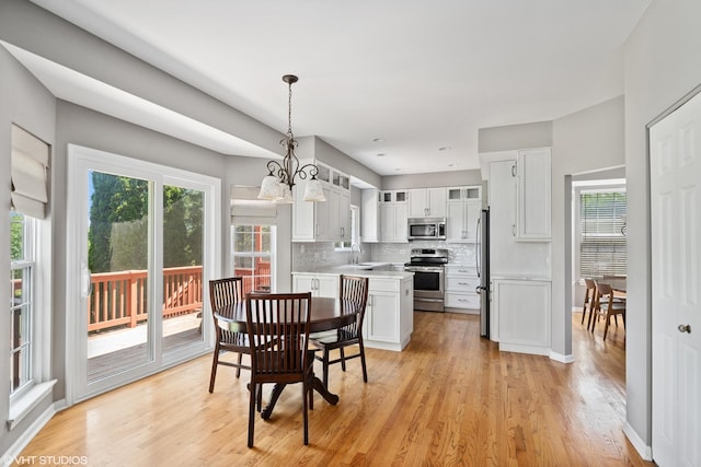 6162 Crossland Blvd, Gurnee, IL 60031 - dining area featuring light wood-type flooring and a chandelier