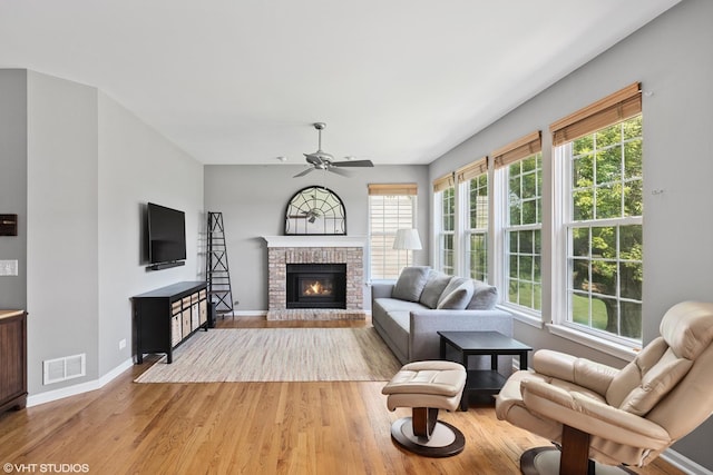 6162 Crossland Blvd, Gurnee, IL 60031 - living area with ceiling fan, light wood-style flooring, plenty of natural light, and a brick fireplace