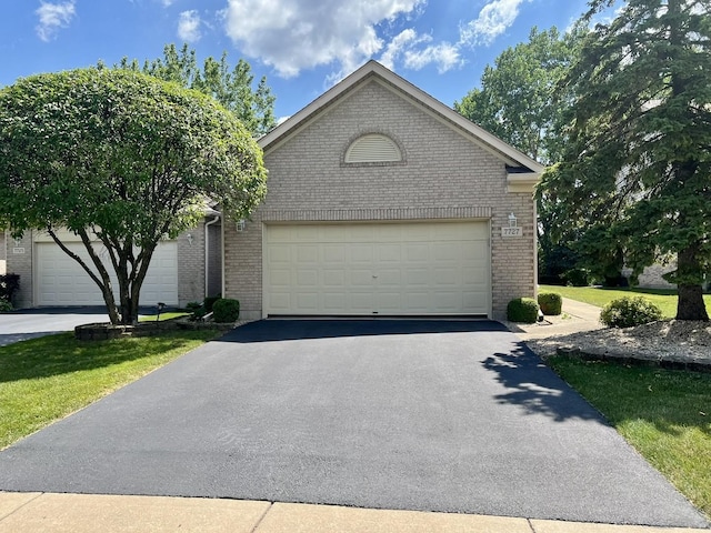 7727 Bristol Park Dr Unit 7727, Tinley Park, IL 60477 - view of front of home with brick siding, a garage, and driveway
