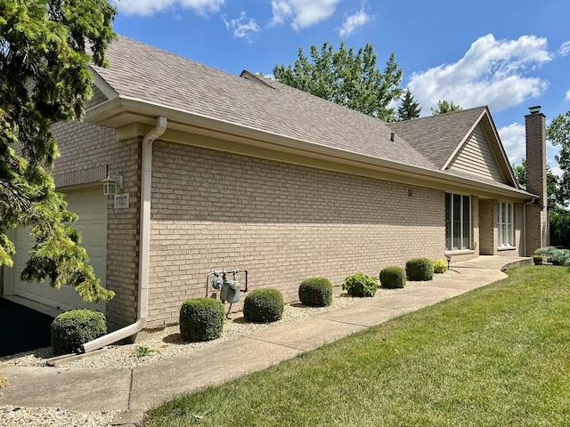 7727 Bristol Park Dr Unit 7727, Tinley Park, IL 60477 - view of side of property with an attached garage, brick siding, roof with shingles, a lawn, and a chimney