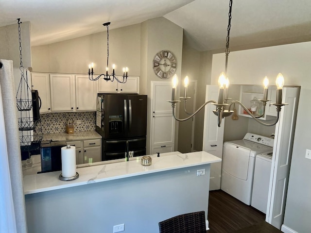 7727 Bristol Park Dr Unit 7727, Tinley Park, IL 60477 - kitchen with washer and dryer, black fridge, a chandelier, vaulted ceiling, and a peninsula