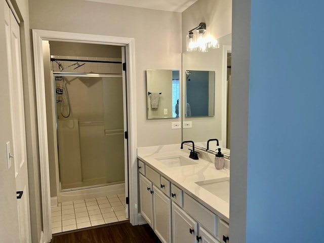 7727 Bristol Park Dr Unit 7727, Tinley Park, IL 60477 - full bathroom featuring a shower stall, double vanity, and wood finished floors