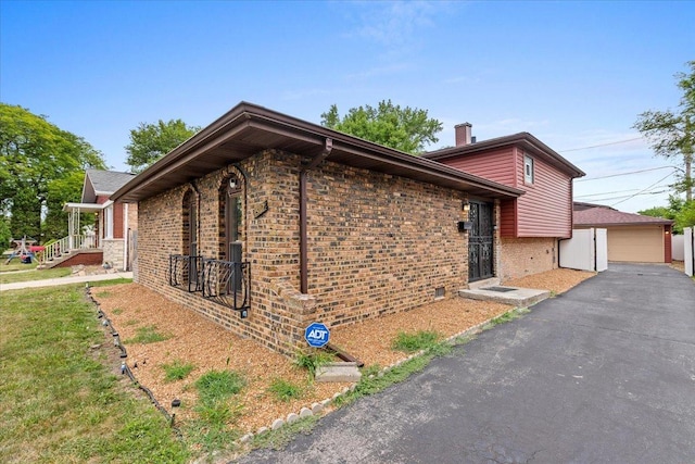 15117 Madison Ave, Dolton, IL 60419 - view of home's exterior with brick siding, a garage, and a chimney