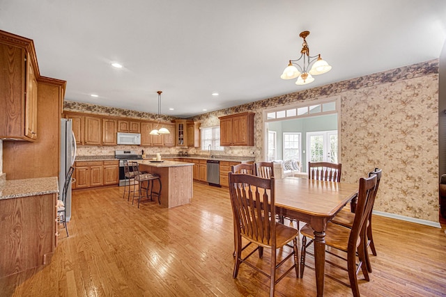 541 Clover Dr, Algonquin, IL 60102 - dining room featuring light wood-style flooring, a chandelier, and wallpapered walls