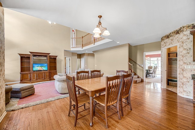541 Clover Dr, Algonquin, IL 60102 - dining space featuring stairway, light wood finished floors, a chandelier, and a high ceiling