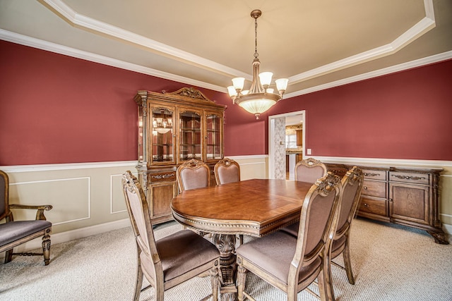 541 Clover Dr, Algonquin, IL 60102 - dining area with a tray ceiling, light carpet, a chandelier, a wainscoted wall, and crown molding