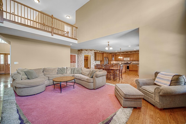 541 Clover Dr, Algonquin, IL 60102 - living area featuring light wood-style floors, a high ceiling, a chandelier, and recessed lighting
