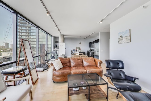 860 W Blackhawk St Unit 805, Chicago, IL 60642 - living room featuring rail lighting, light wood-style floors, and floor to ceiling windows