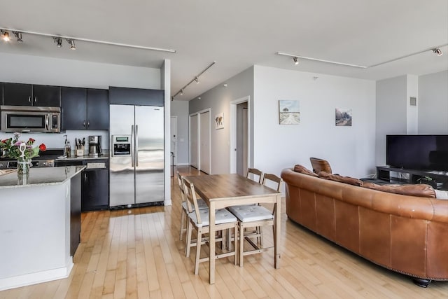 860 W Blackhawk St Unit 805, Chicago, IL 60642 - kitchen featuring appliances with stainless steel finishes, track lighting, dark cabinets, and light wood finished floors