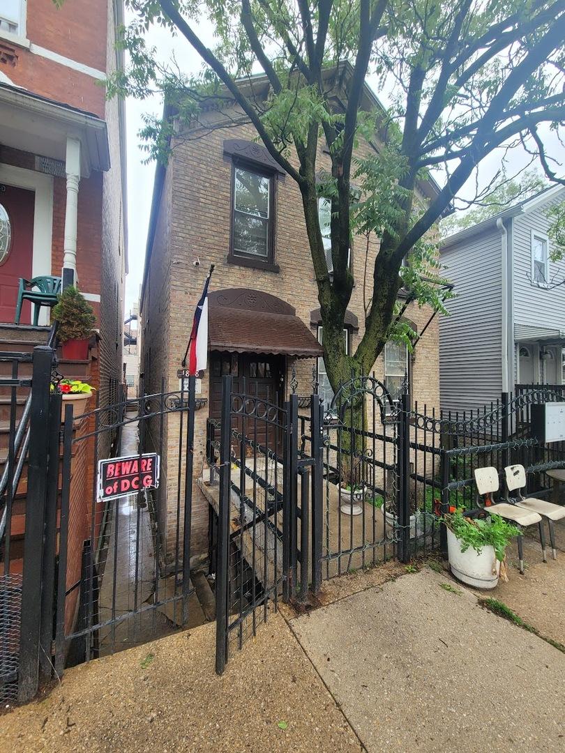 1838 S Laflin St, Chicago, IL 60608 - view of front facade featuring a gate, brick siding, and a fenced front yard